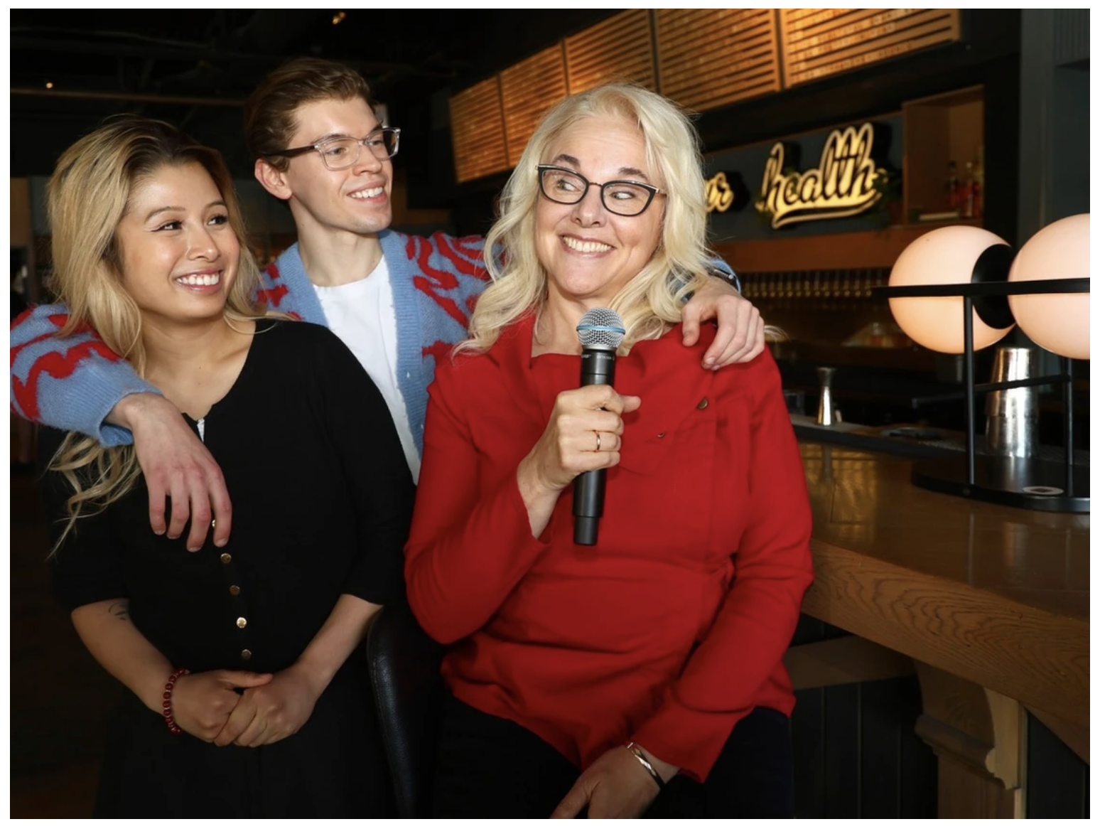 Belinda Fox speaking with a microphone at Boozy Lectures